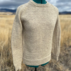 Beige sweater on a mannequin against a natural background