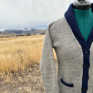 Gray jacket with blue accents on a mountain landscape